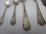five spoons and two spoons sitting on a table