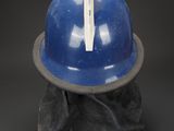 a blue hard hat with a stick sticking out of it