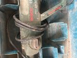 a drill in a box with other tools in it