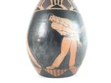a vase with a picture of a man playing a game of tennis