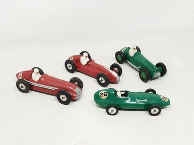 several toy cars are lined up in a row on a white surface