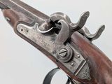 a close up of a gun on a white background with a white background