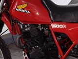 a red motorcycle that is parked in a garage