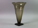 a glass vase that is sitting on a black stand