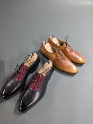 three pairs of shoes sitting on top of a table next to each other