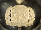 a black helmet with a gold emblem on it