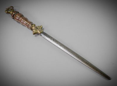 a close up of a knife on a table with a white background