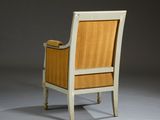 a white chair with a wooden seat and arm rest on a gray surface