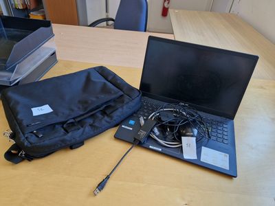 un ordinateur portable posé sur une table en bois