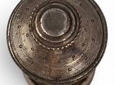 a close up of a metal object on a white surface