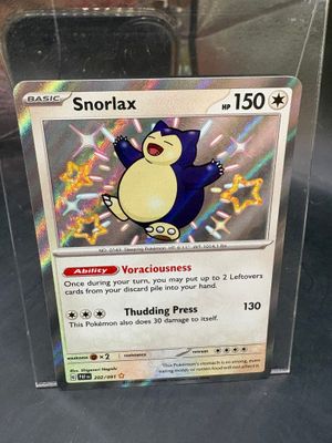 a pokemon card in a clear box on a table