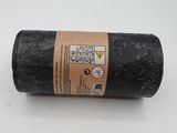 a close up of a roll of black felt on a white surface
