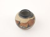a black and white vase on a white surface