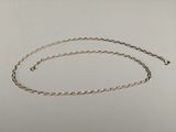 a close up of a silver chain on a white surface