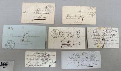 several old envelopes are displayed on a table in a display case