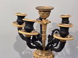 a black and gold candelab with five candles