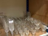 many glasses on a shelf in a store