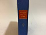 a blue book sitting on top of a table next to a white wall