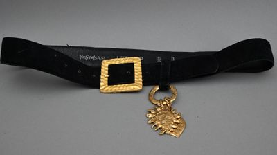 a close up of a belt with a gold buckle on it