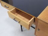 a desk with two drawers and a black top