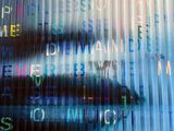 a blurry image of a person ' s face with letters on it