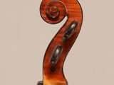 an old violin with a wooden back and bow on a white background