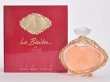 a close up of a bottle of perfume next to a red box