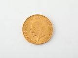 a close up of a gold coin on a white surface