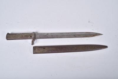 two old knives sitting on top of a table next to each other