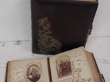 an open book sitting on a table next to a book with pictures on it