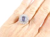 an image of a woman ' s hand with a diamond and sapphire ring