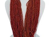 necklace with red beads and blue beads on a white mannequin