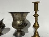 three brass vases sitting next to each other on a table