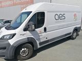 a white van parked in front of a building