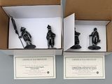 two boxes with figurines in them on a table