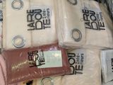 many bags of clothing that are wrapped in plastic