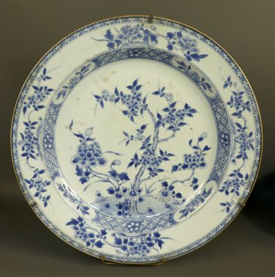 a blue and white plate with flowers on it