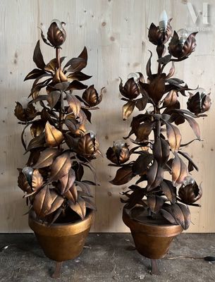 two vases that have flowers in them on a table