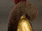 a gold helmet with a red mohawk on top of it