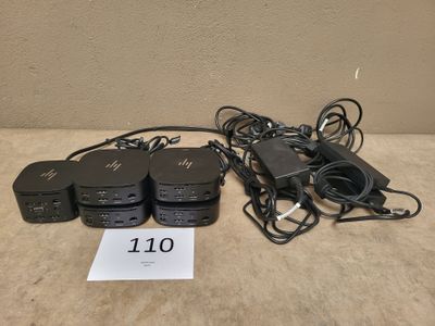 a lot of power cords and a charger on the table