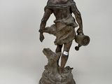 bronze statue of a man with a dog on a pedestal