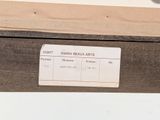 a label on a piece of wood that is on a shelf