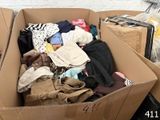 a cardboard box filled with clothes and other items