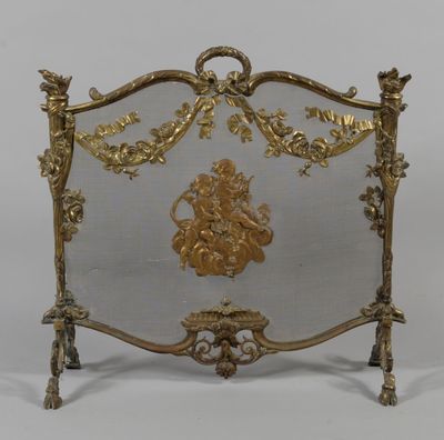 an image of a gold colored fireplace screen sitting on top of a table