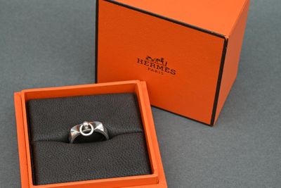an orange box with a silver ring inside of it on a table