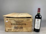 a wooden box with a bottle of wine next to it