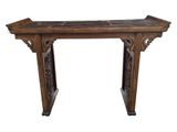 an old wooden table with carvings on the top of it