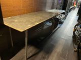 an image of a kitchen with a table in the middle of the room