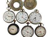 a lot of different types of pocket watches on display