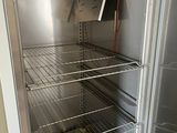 an open refrigerator with a lot of shelves in it